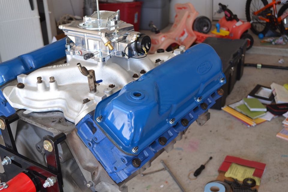Ford V8 engine with blue valve covers and carburetor