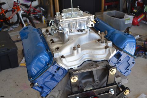 1981 Ford F-250 - Close-up of an engine block assembly, a carburetor and blue valve covers.