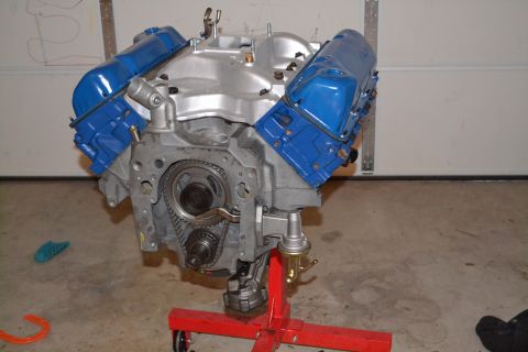 1981 Ford F-250 - A Ford V8 engine is shown on a red engine stand, blue valve covers and exposed timing components.