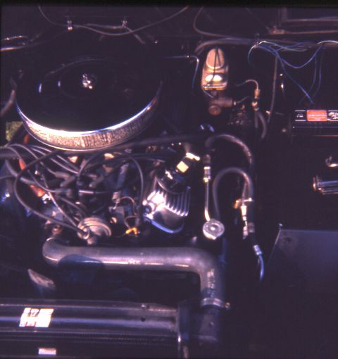 1996 Ford Bronco - Close-up view of an engine bay, showing various mechanical components and wiring.