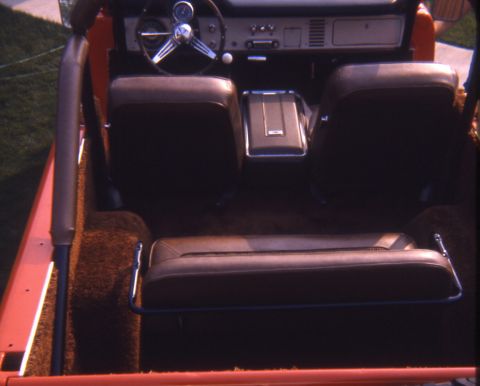 1996 Ford Bronco - The interior of a 1996 Ford Bronco features brown upholstery and carpeting, with a view of the dashboard and steering wheel.