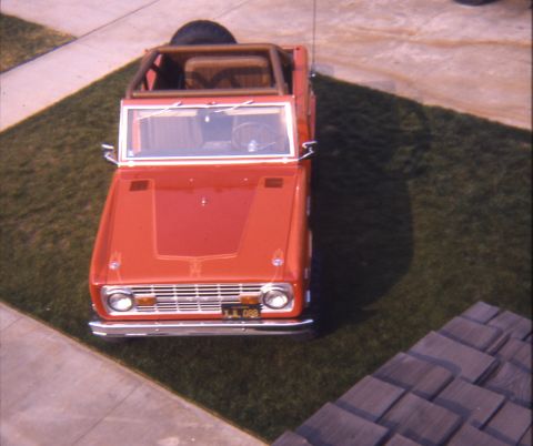 1996 Ford Bronco - This red first-generation Ford Bronco is parked on a lawn. The license plate reads XJL 088.