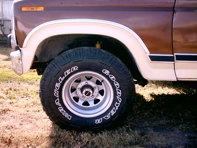 1980 Ford Bronco front wheel with Goodyear Wrangler tire and chrome bumper