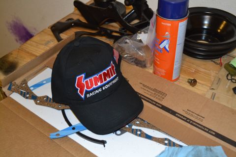 1981 Ford F-250 - Workbench with Summit Racing hat, spray can, and engine parts laid out.