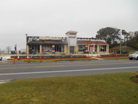 1994 Ford Bronco - A commercial building shows significant fire damage, with rainbow flags and caution tape visible outside.