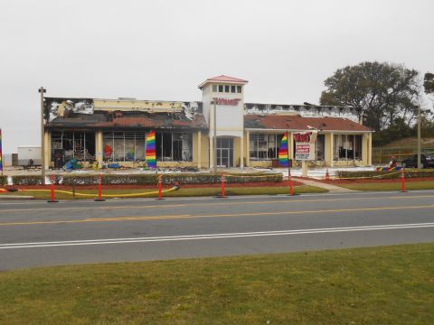 1994 Ford Bronco - A commercial building shows extensive fire damage, with rainbow flags and caution tape visible.