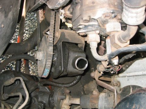 1973 Ford F-100 - Close-up view of a vehicle's power steering pump and drive belt system.