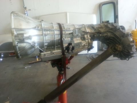 1994 Ford Bronco - Transmission and driveshaft assembly, likely removed from a vehicle for repair or replacement.
