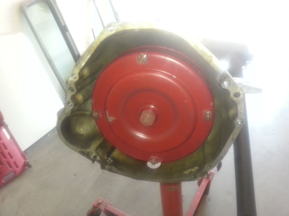 Transmission torque converter with red bell housing, mounted on a stand
