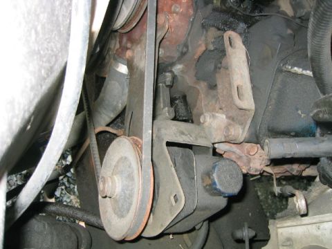 1973 Ford F-100 - Close-up view of an engine's belt and pulley system, showing wear and tear.