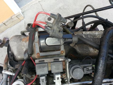 1994 Ford Bronco - Close-up view of engine components, including ignition coil and spark plug wires.