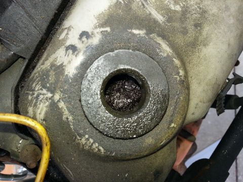 1994 Ford Bronco - This is a close-up view of a greasy metal part with a hole in the center.