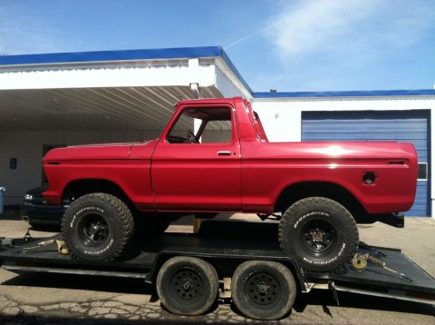 1978 Ford Bronco - A bright red 1978 Ford Bronco is seen on a trailer, equipped with BFGoodrich Mud-Terrain T/A tires.