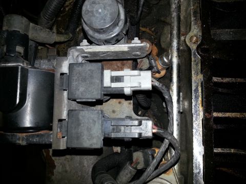 1994 Ford Bronco - Close-up view of electrical relays and wiring harness in an engine compartment.