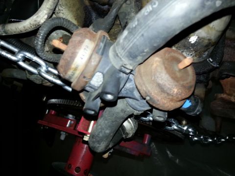 1994 Ford Bronco - This image shows engine components, a chain, and a red jack, not a 1994 Ford Bronco.