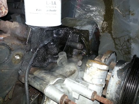 1994 Ford Bronco - Close-up view of an engine block an oil filter and associated components.