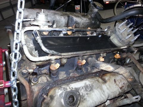 1994 Ford Bronco - Close-up view of an engine, likely undergoing maintenance or repair.