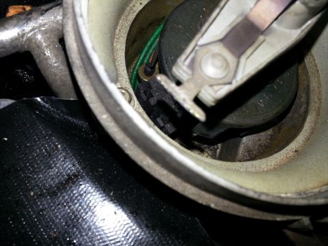 1994 Ford Bronco - Distributor cap and rotor assembly, likely from an older vehicle.