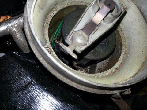 1994 Ford Bronco - This image shows a close-up view of a vehicle's ignition distributor cap and rotor, a critical component for engine timing.