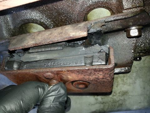 1994 Ford Bronco - A close-up view shows a broken engine mount, revealing a part number stamped into the metal component.