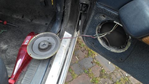 1991 Ford LTD Crown Victoria - The interior of a car door is shown with the speaker removed, revealing wiring and the empty mounting hole.