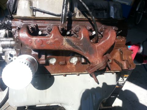 1994 Ford Bronco - This image shows a close-up of a Ford engine, likely a V8, with visible rust and an oil filter. The registry claims it's a 1994 Ford Bronco…