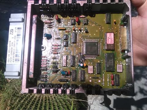 1992 Ford Bronco - Close-up of a Ford EEC-IV engine control unit, showing its internal circuitry and connectors.