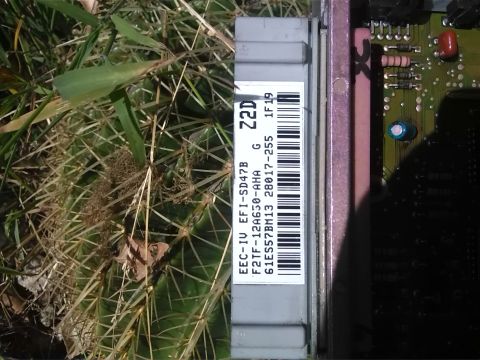 1992 Ford Bronco - Close-up of an EEC-IV engine control unit, part number F2TF-12A650-AHA, with visible text and a barcode.