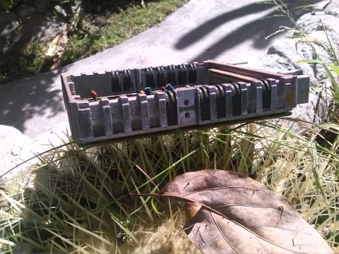 1992 Ford Bronco - An electronic control unit rests on the grass, partially obscured by a fallen leaf.