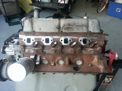 1994 Ford Bronco - This V8 engine block is shown with its exhaust ports and spark plugs visible, along with an attached oil filter.