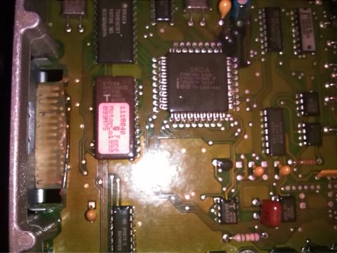 1992 Ford Bronco - This is a close-up view of an electronic control unit's circuit board, showing integrated circuits and other electronic components.
