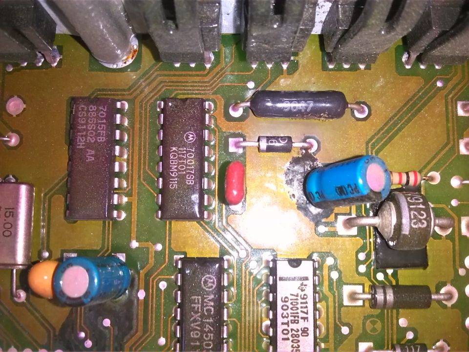 Circuit board with integrated circuits, capacitors, resistors, and diodes. Text visible on components includes '7015FB', 'MC1450', '9123', and 'SUPER MOTORS'