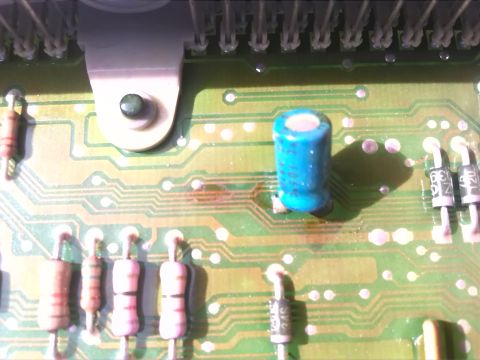 1992 Ford Bronco - Electronic circuit board with various components, including a blue capacitor and resistors.