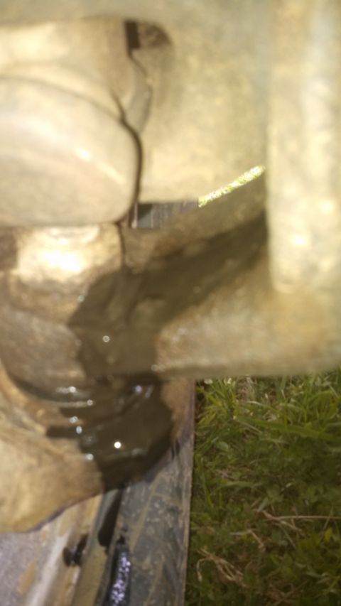 1979 Ford Bronco - Dark fluid is leaking from the undercarriage of a vehicle.