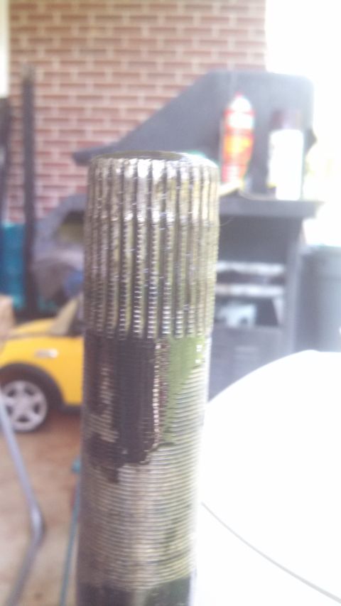 1979 Ford Bronco - A close-up view of a splined shaft, with a blurred yellow toy car visible in the background.