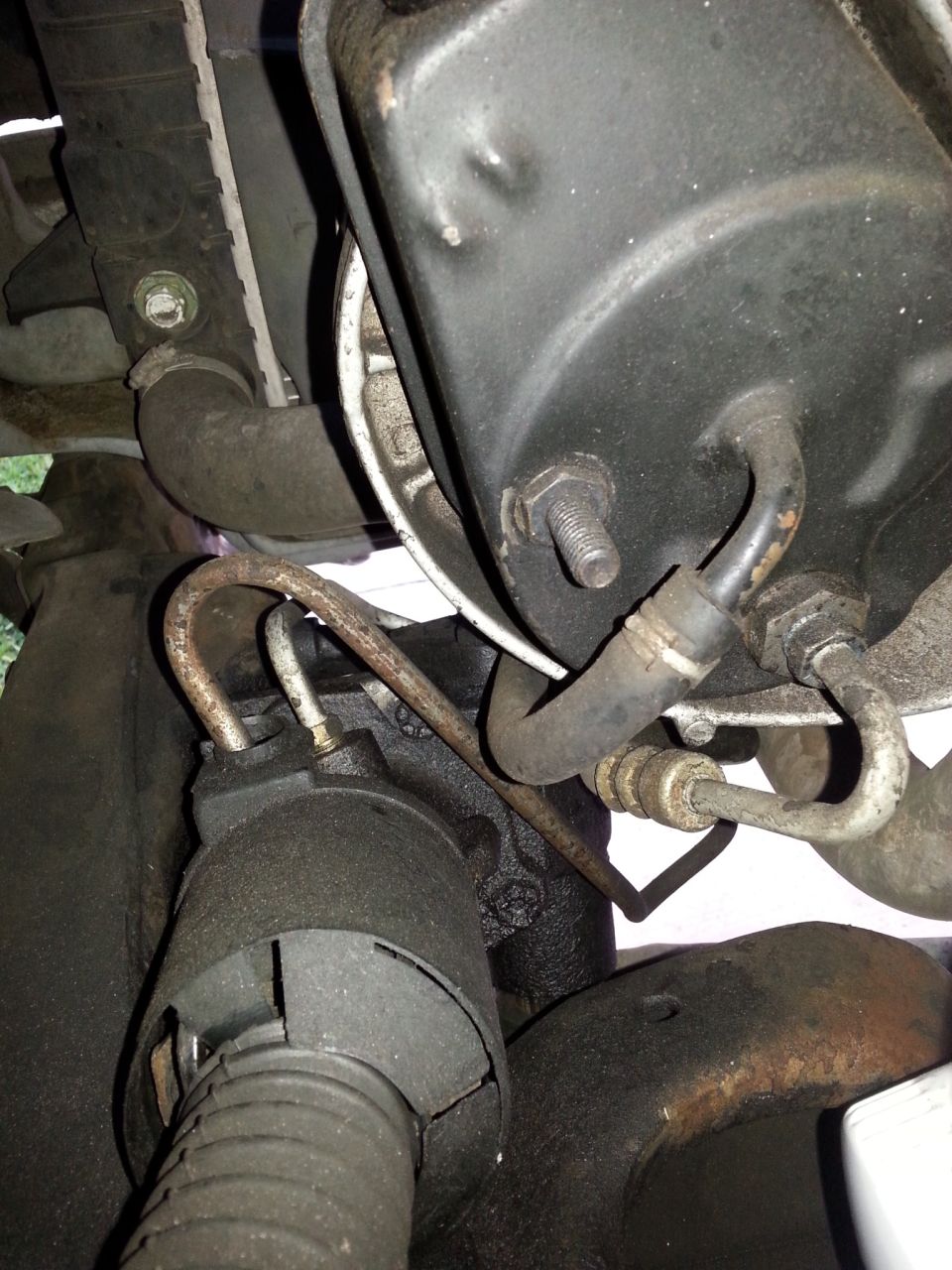 This is the hose from an early '90s Ford van, NAPA part 7-1483, the routing is a little unusual, but it works and all of the connections bolt up without binding.