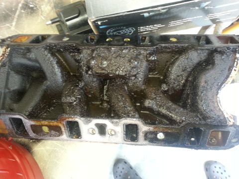 1994 Ford Bronco - This intake manifold appears to be heavily soiled with oil and grime, obscuring any potential identifying marks.