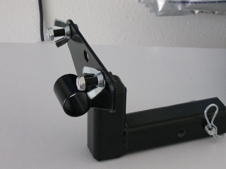Black metal hitch receiver accessory mount with wing nuts and a clevis pin