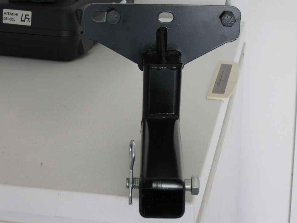 Black metal hitch receiver part with pin and bolt