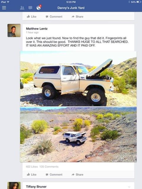 1988 Ford Bronco - A white Ford Bronco sits on a dirt road in a desert, its hood open, with a second, smaller vehicle visible in the distance.