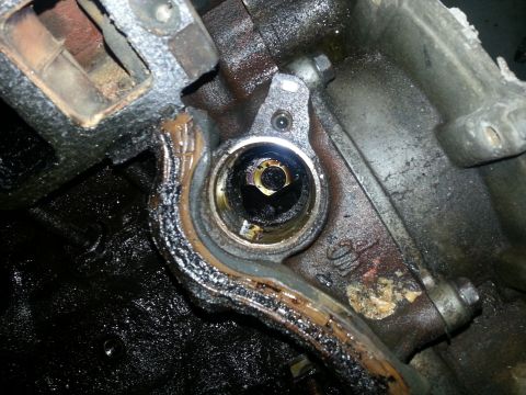 1994 Ford Bronco - Engine component with visible oil and gasket material, likely requiring replacement.
