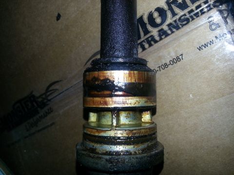 1994 Ford Bronco - Close-up of a greasy, worn metal shaft, possibly a component from a transmission or drive system.