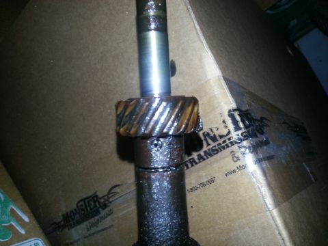 1994 Ford Bronco - Close-up of a metal shaft with a gear, part of a transmission.