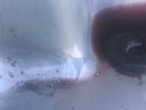 1992 Ford Bronco - Dark fluid with debris is visible in a clear container, with a Supermotors.net logo in the corner.