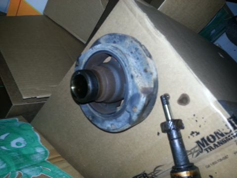 1994 Ford Bronco - Close-up of a used automotive part, possibly a bearing or strut mount, on a cardboard box.
