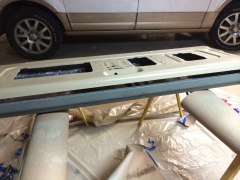 1996 Ford Bronco - A vehicle tailgate is being prepped for painting, with a white SUV visible in the background.