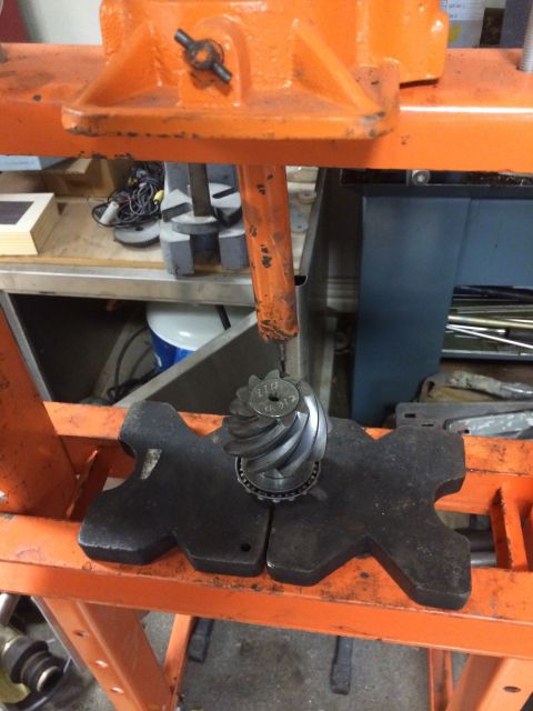 1996 Ford Bronco - Differential gear set being worked on in a press. Part number visible on gear.