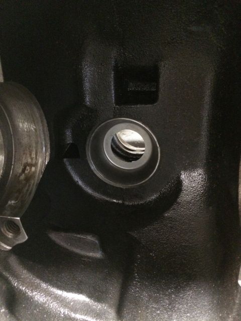 1996 Ford Bronco - Close-up of a black engine component with visible machining marks and a threaded bolt.
