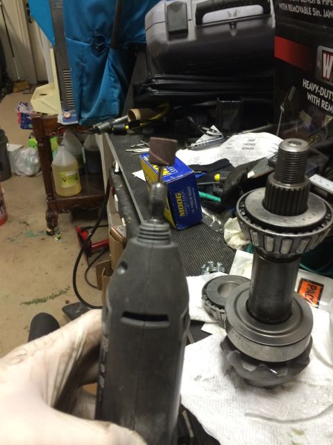 1996 Ford Bronco - Close-up of automotive differential components and a rotary tool, suggesting repair or modification work.
