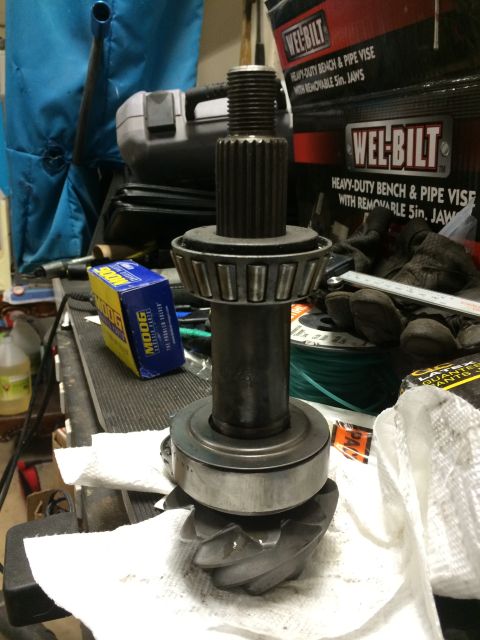 1996 Ford Bronco - Close-up of a differential gear and pinion shaft assembly, with associated parts and packaging visible.